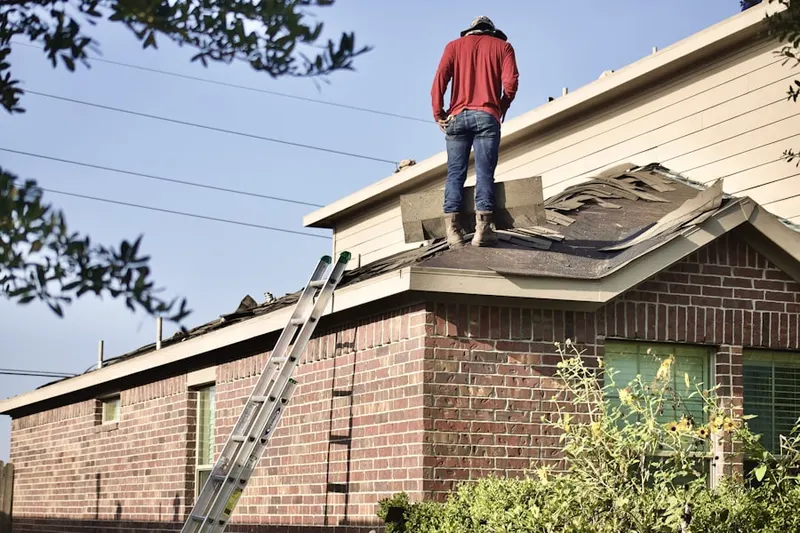 Professional roofer working on a residential roof in New Hempstead